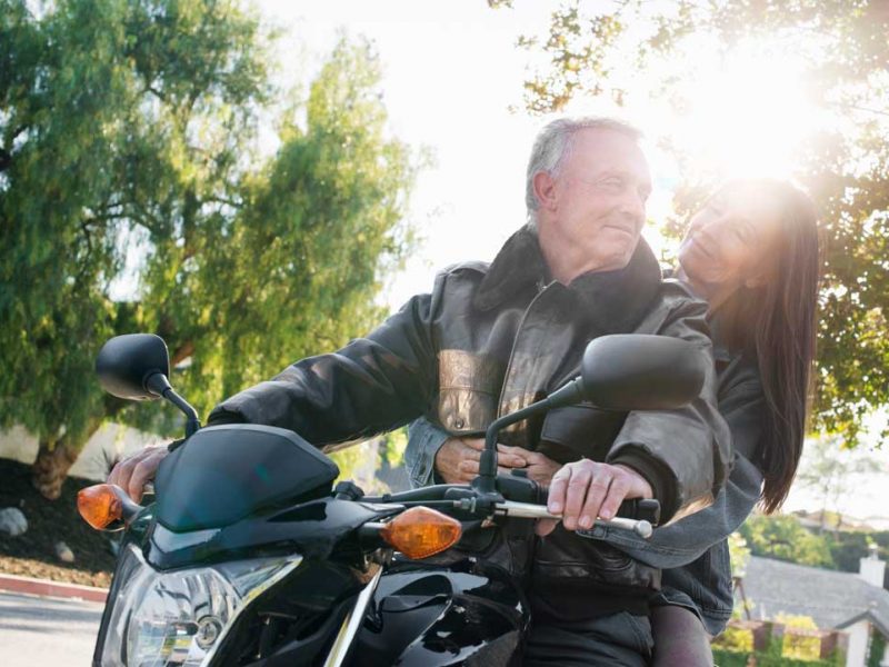 senior-couple-taking-a-ride-on-a-motorcycle-ACK6DL9_web